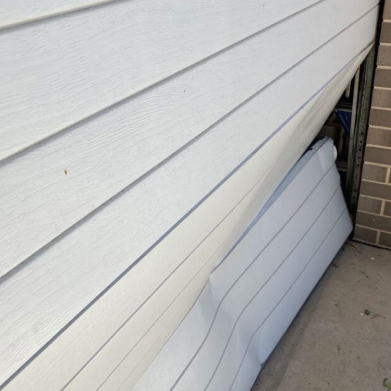 damaged-sectional-garage-door-panel-replacement-repair Sectional Garage Door Panel Replacement - Otto's Garage Door Repairs